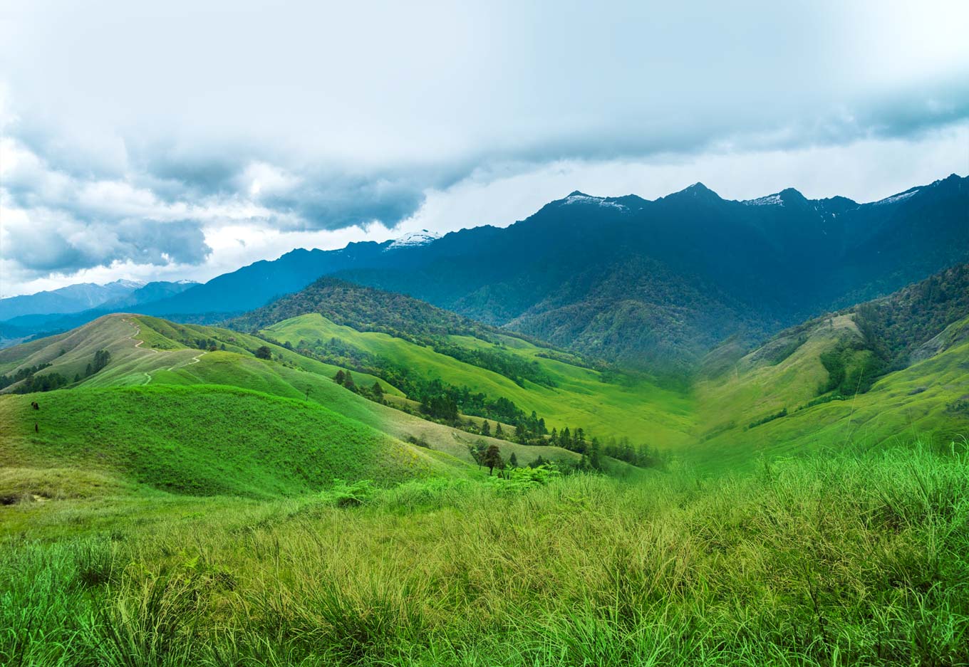 Turquoise lake surrounded by massive snow-capped mountains in the Canadian Rockies